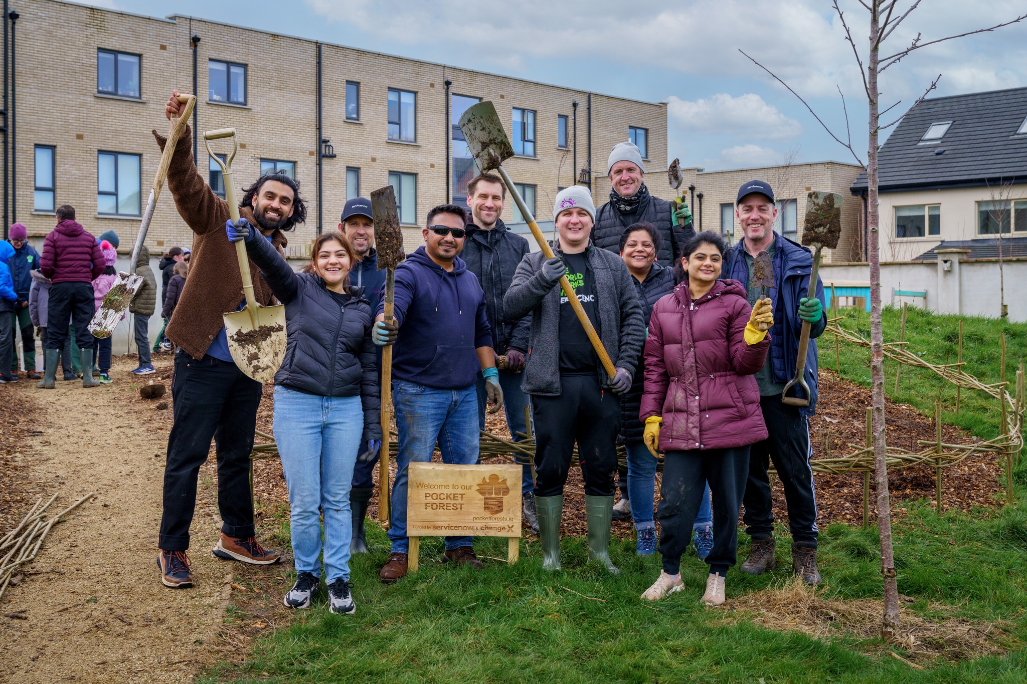 a group of people holding shovels