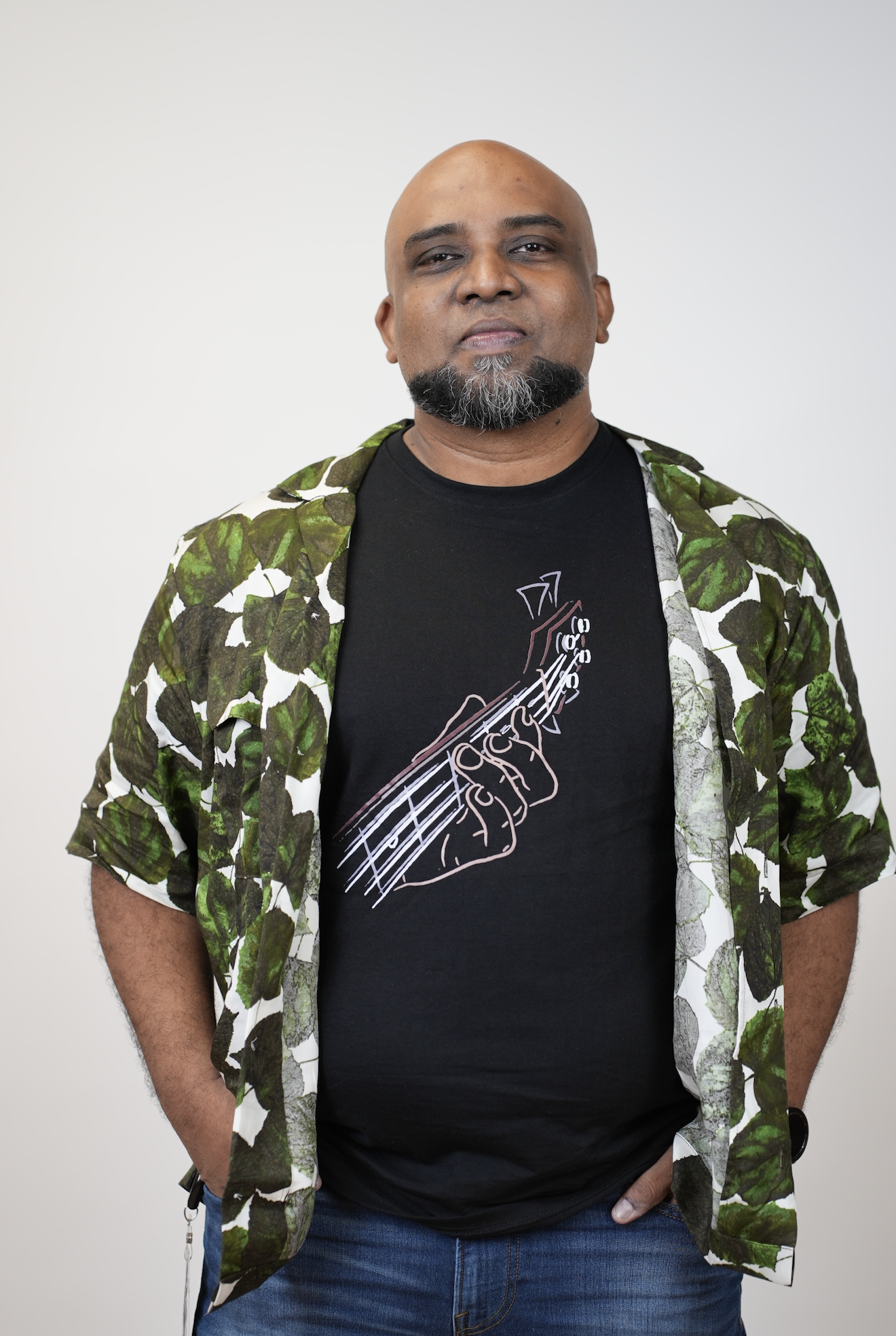 a person with a beard and a shirt with a guitar on it