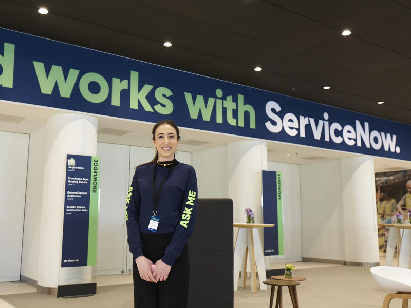 a person standing in front of a sign