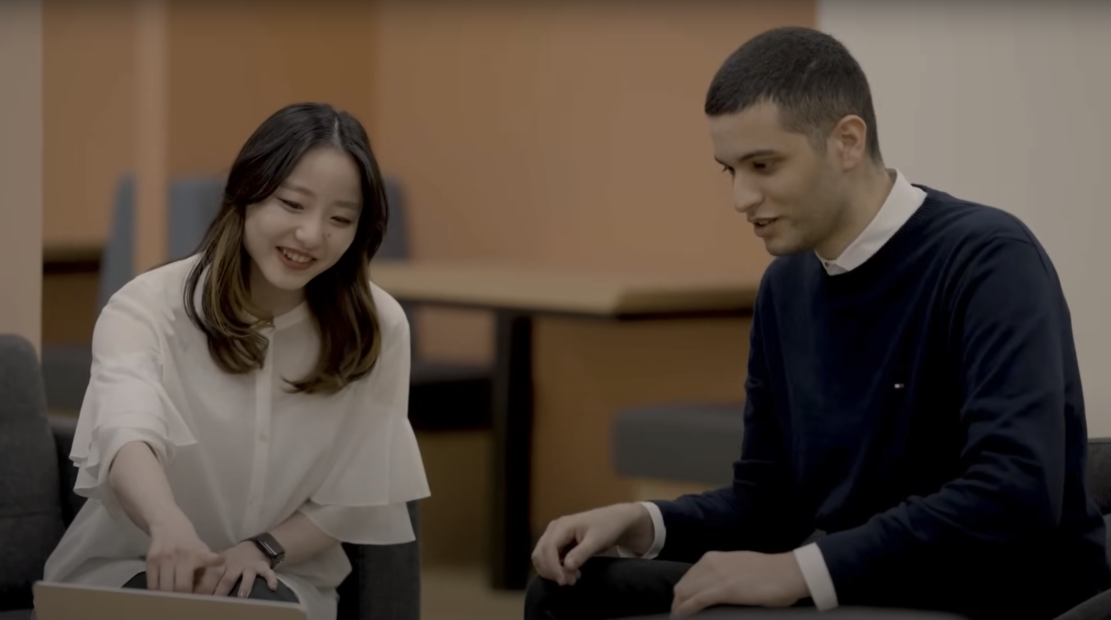 a person and person sitting in a room