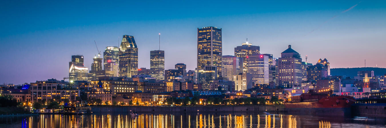 a city skyline with lights reflecting on water