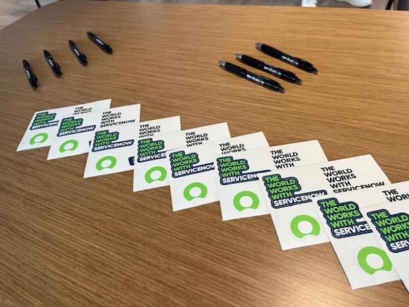 a group of business cards and pens on a table
