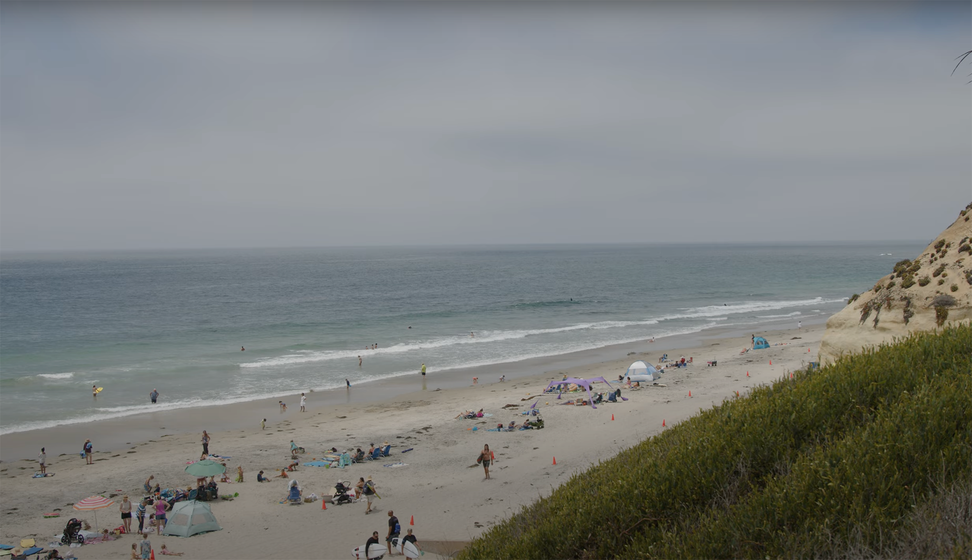 a beach with people and tents