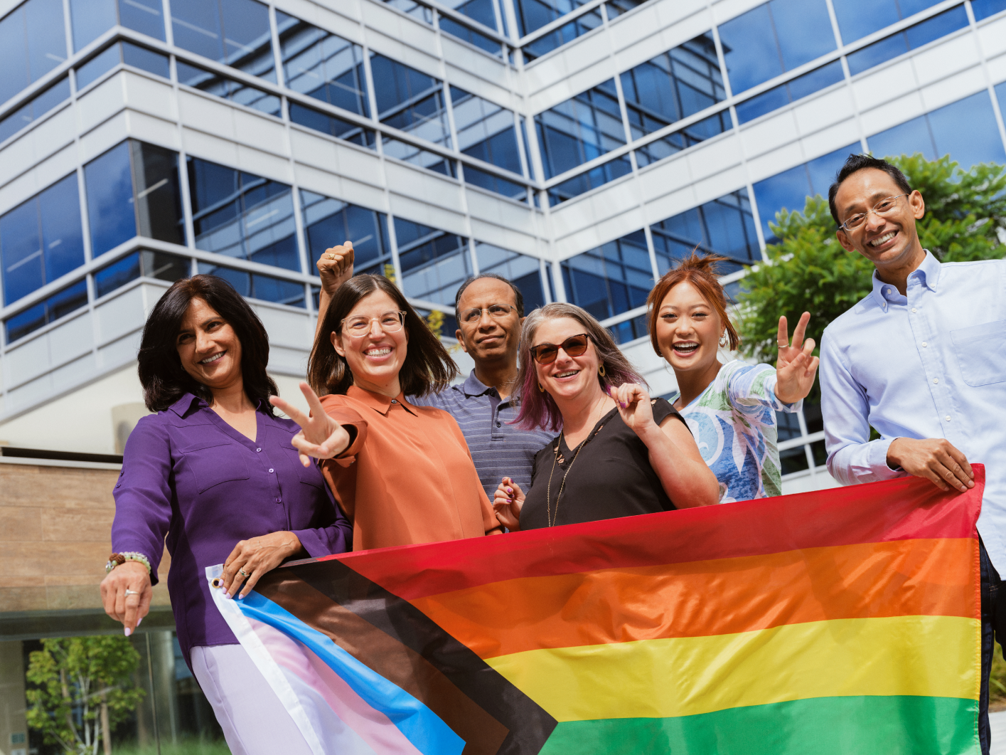 a group of people holding a rainbow flag
