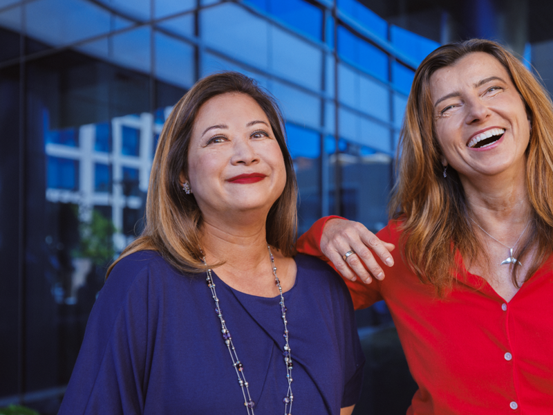 two women smiling and laughing