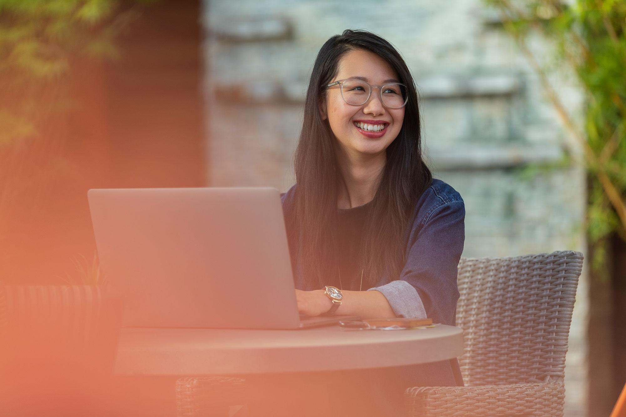 a person smiling at a laptop