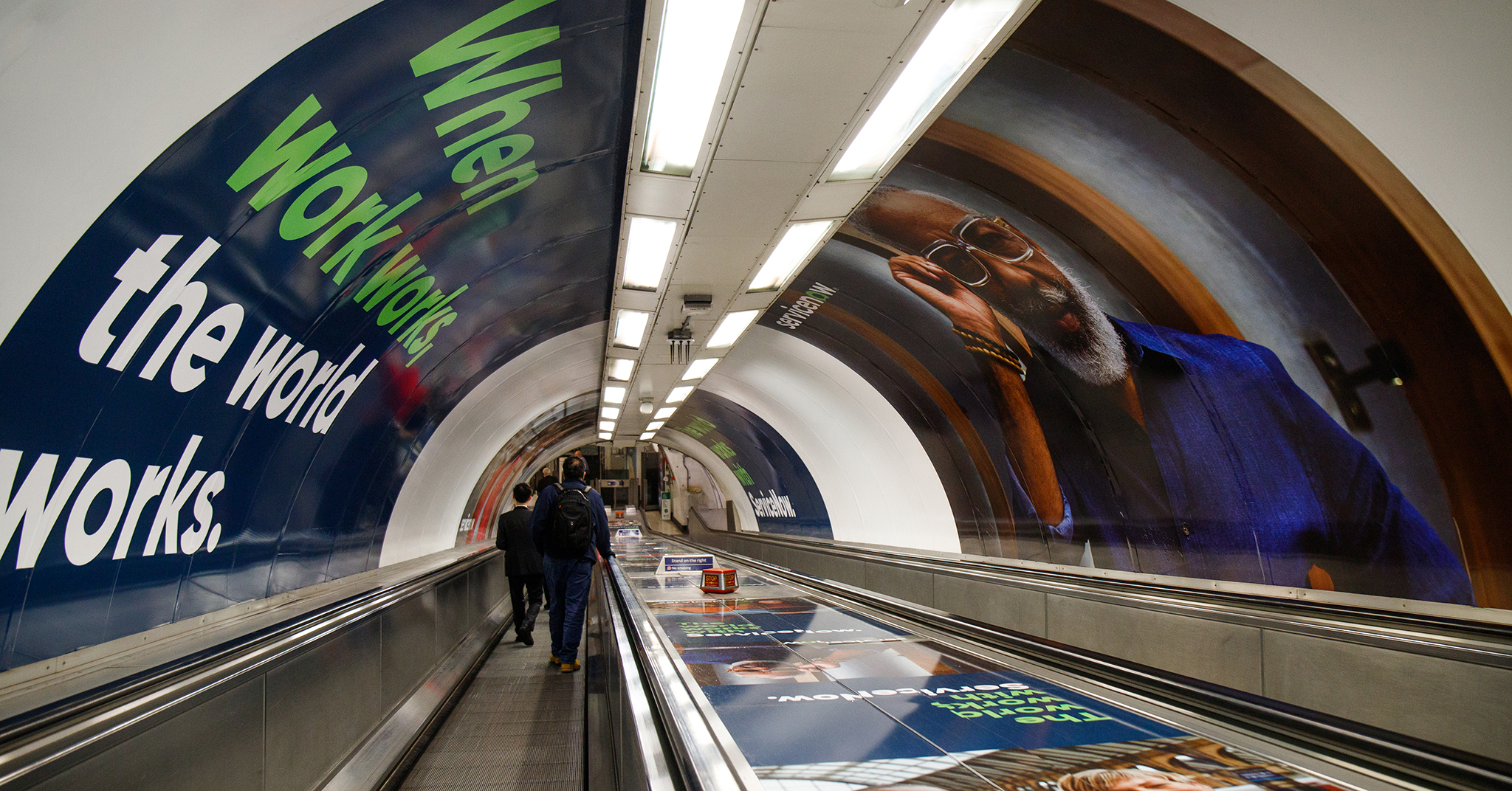 people walking on an escalator
