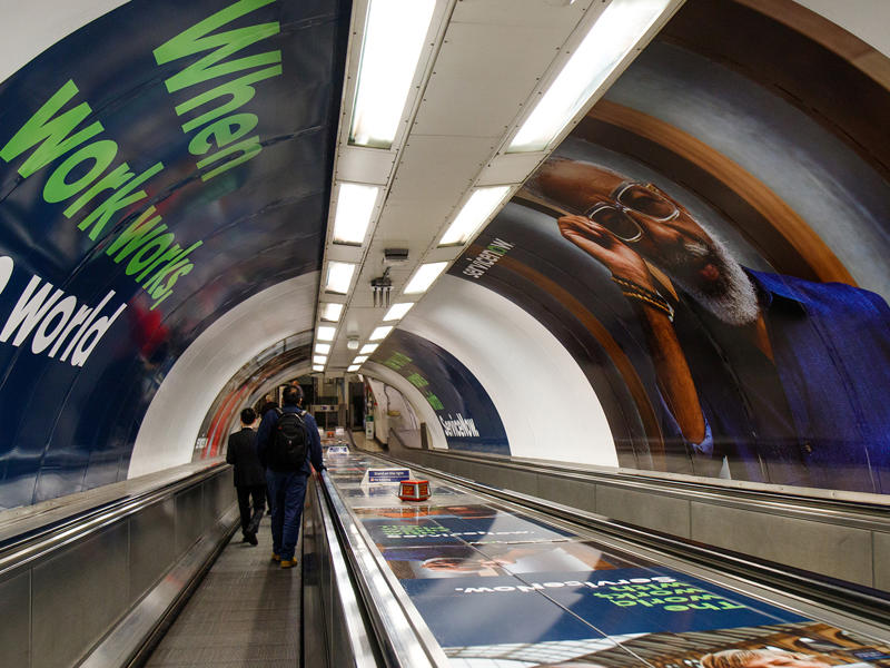 people walking on an escalator