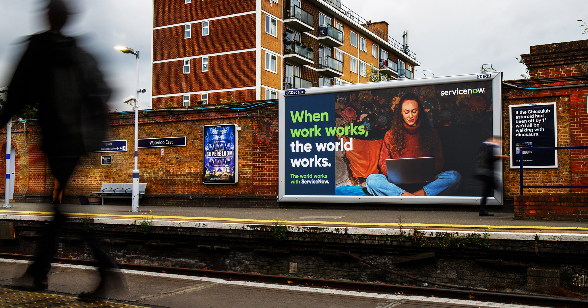 a billboard on the side of a train station