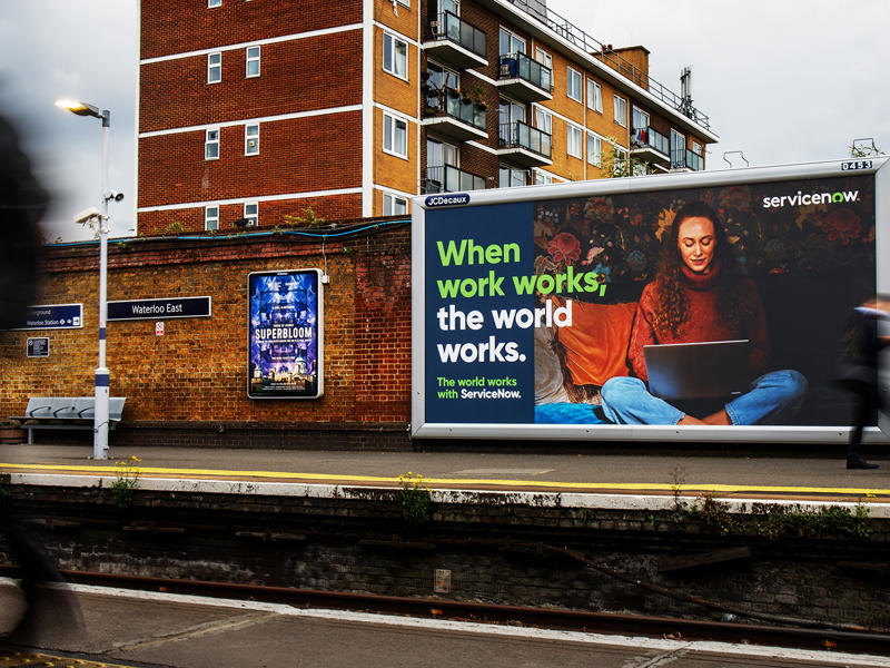 a billboard on the side of a train station