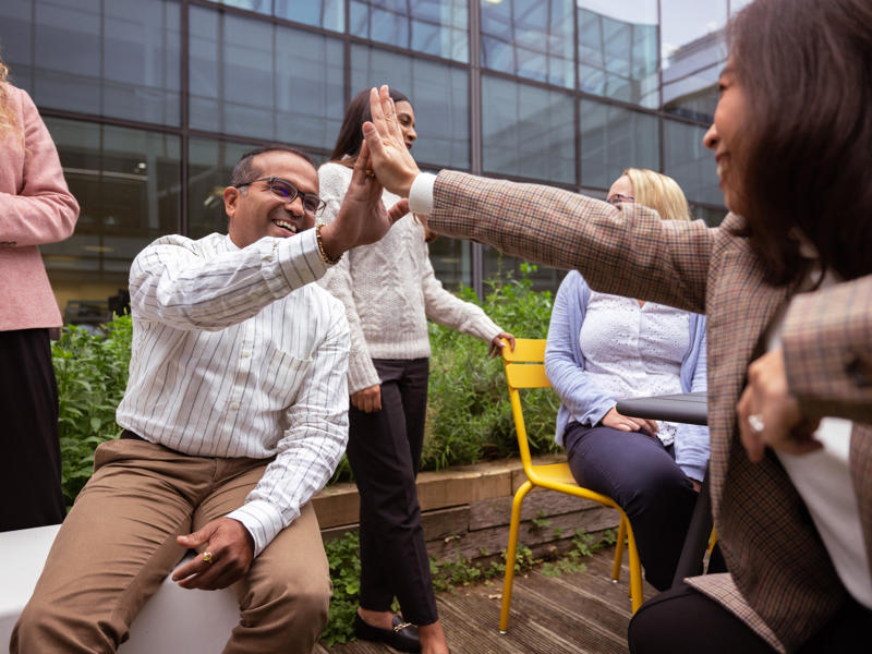 a group of people giving each other a high five