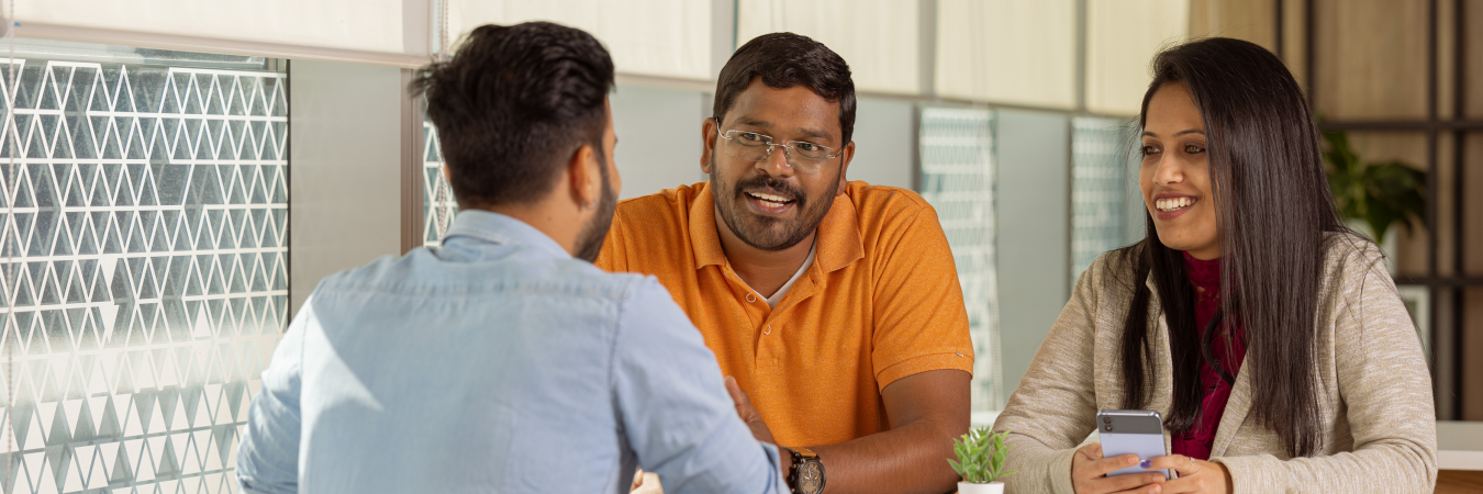 a person in an orange shirt talking to another person