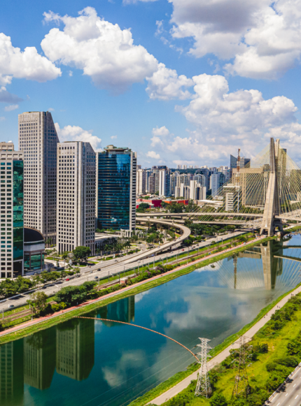 a river with a bridge and a city with buildings
