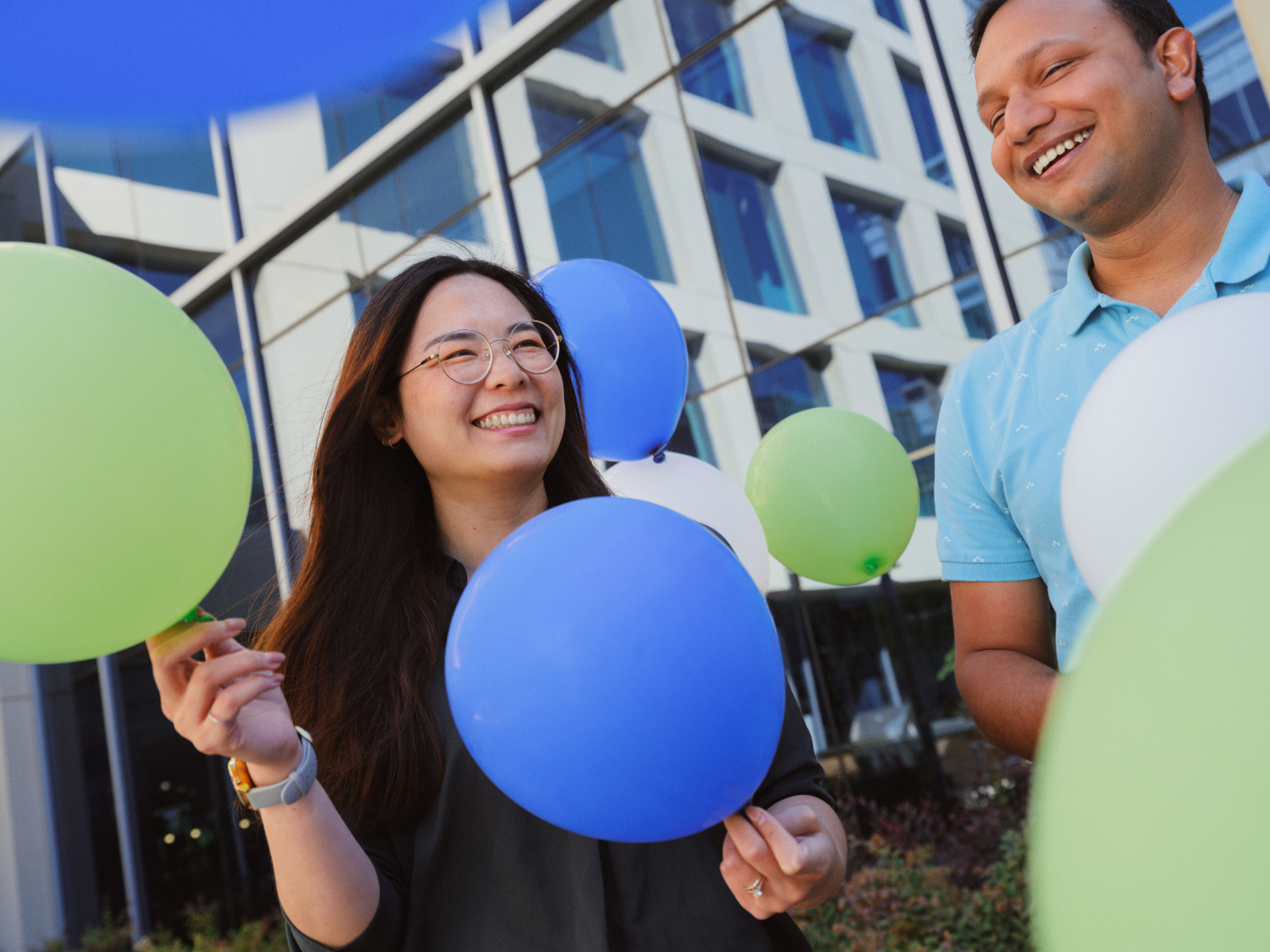 a person and person holding balloons