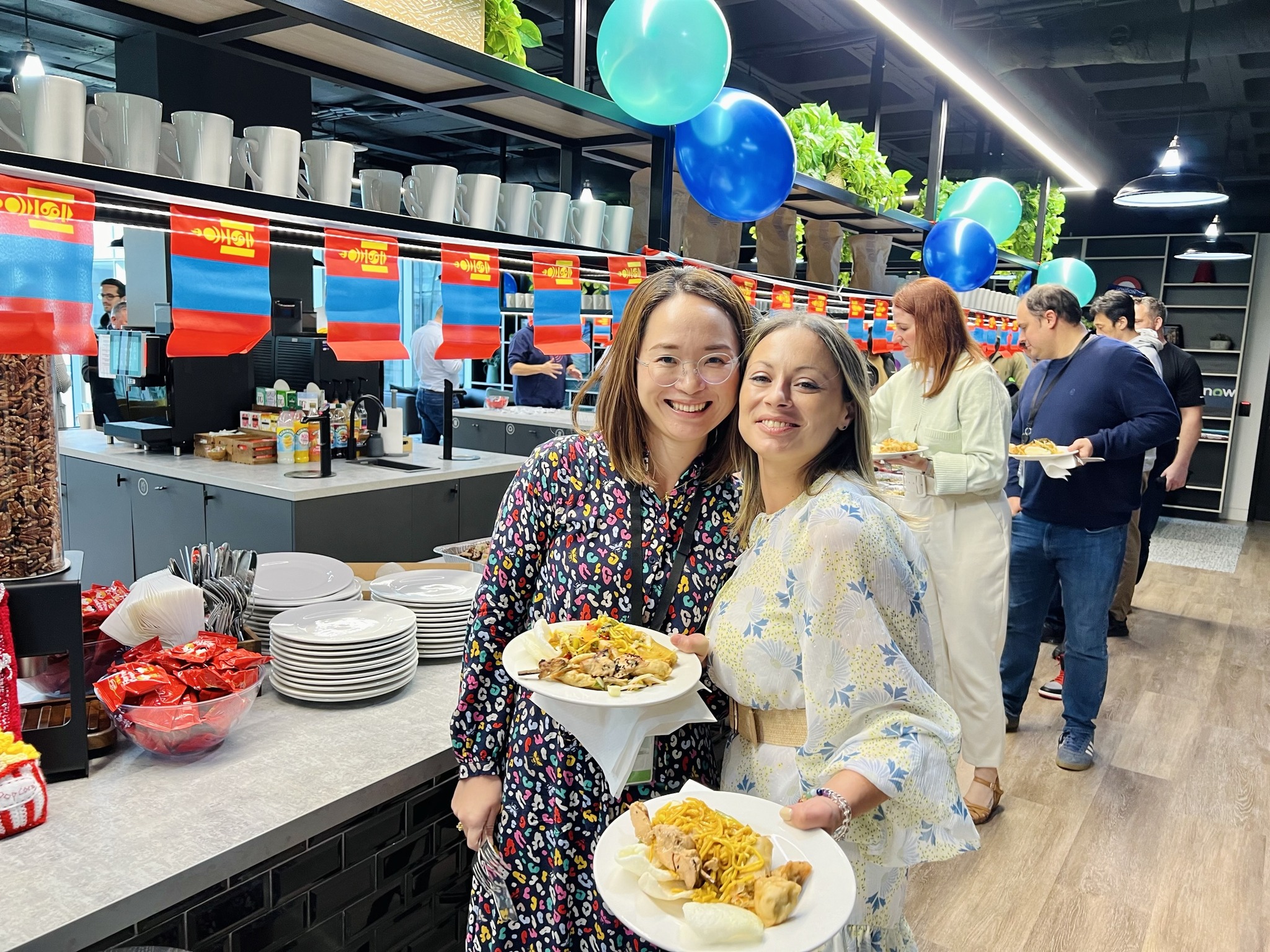 two women holding plates of food