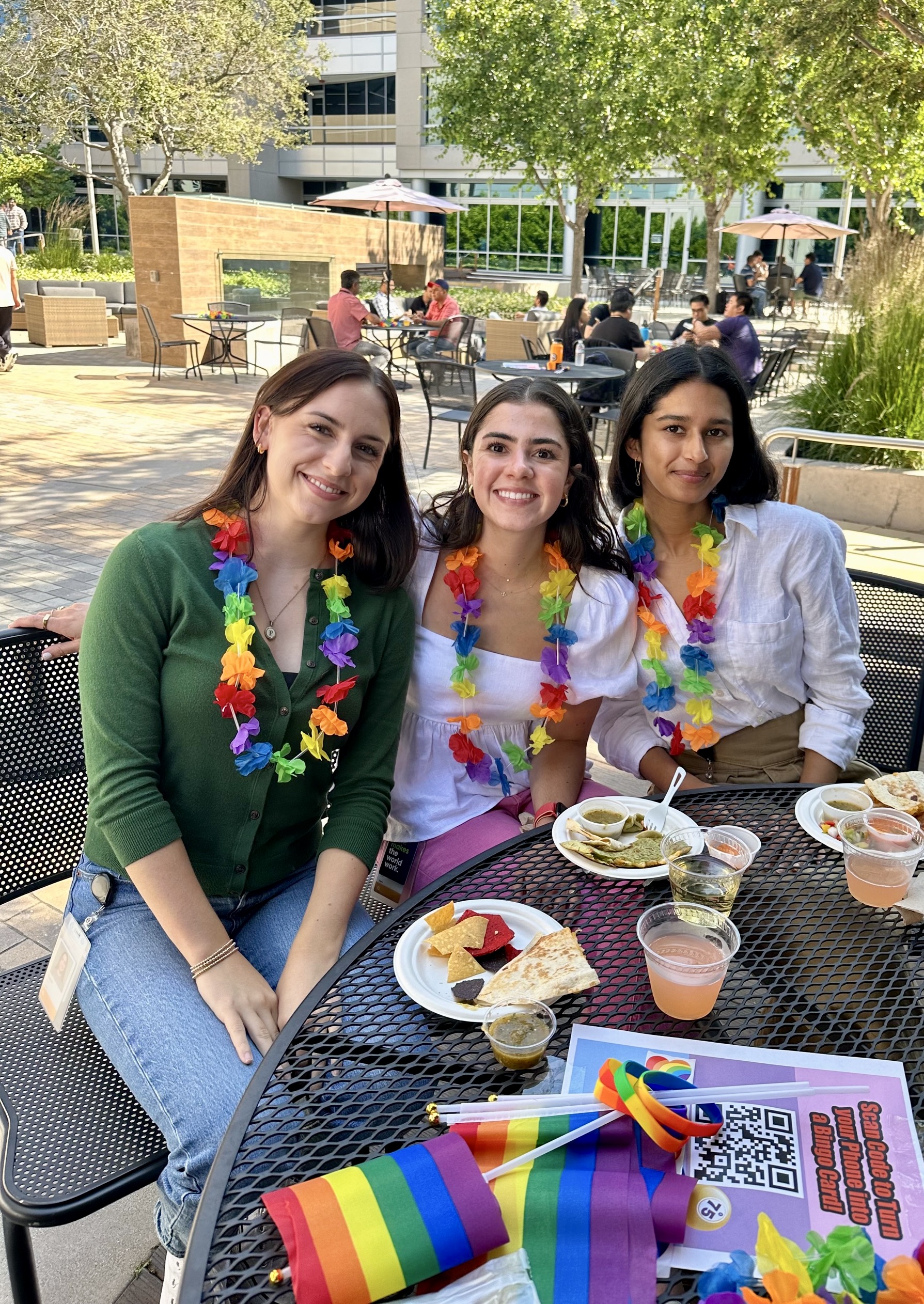 a group of women sitting at a table with food and drinks