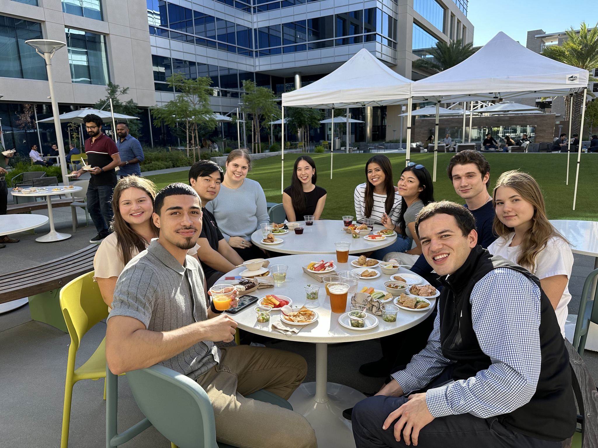 a group of people sitting at a table outside